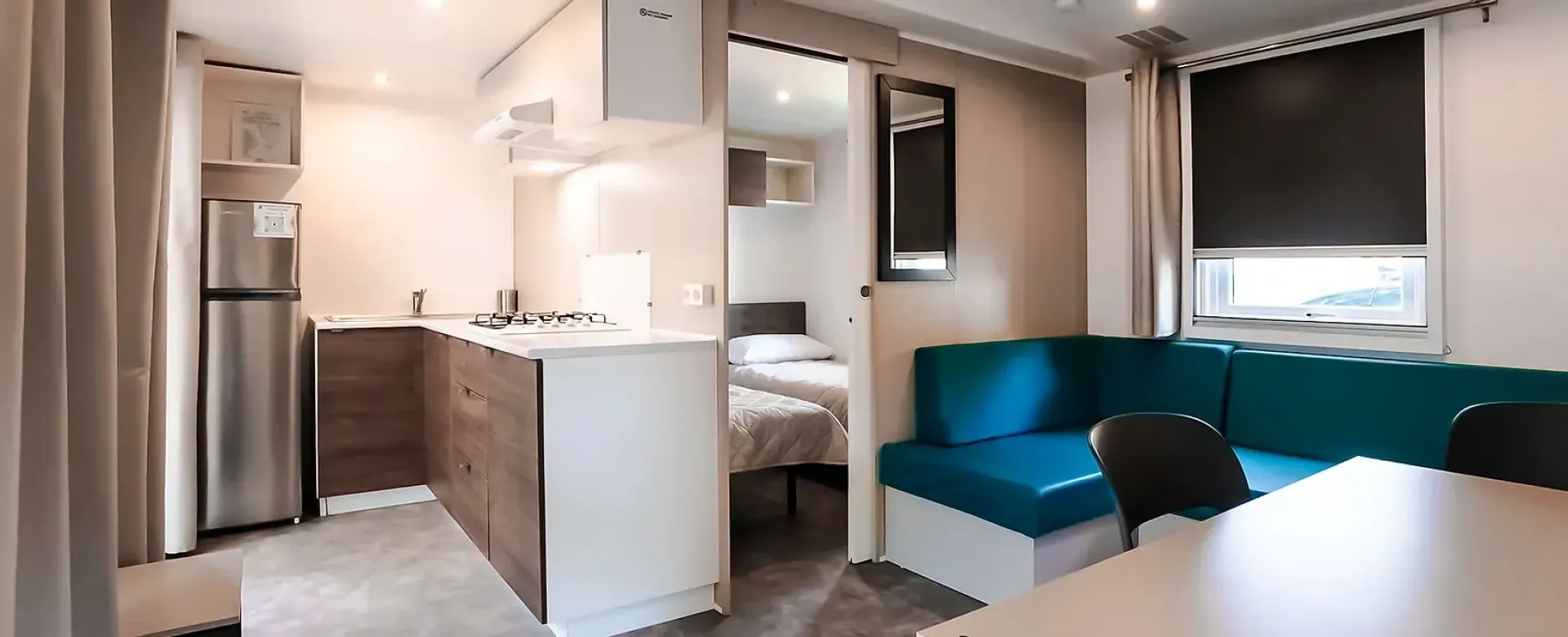 Interno moderno e accogliente con cucina compatta e zona notte separata.